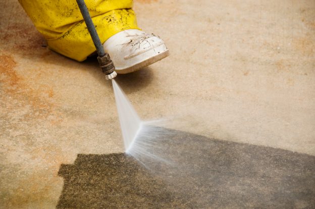 pressure washers a dirty carpet with an accessory