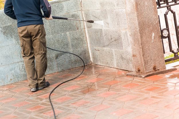 hot water cleaning a brick wall