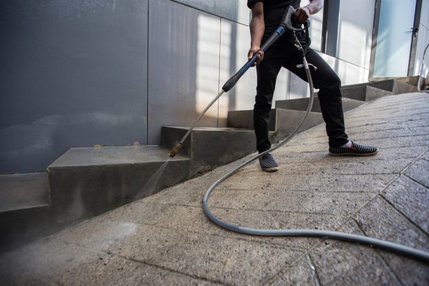 Industry pressure washer being used on a concrete floor