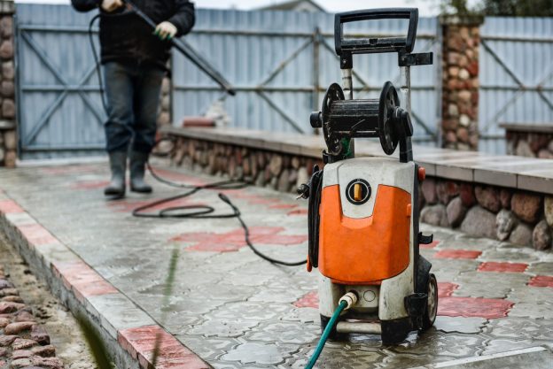 Shot of a pressure washer with a man in the background